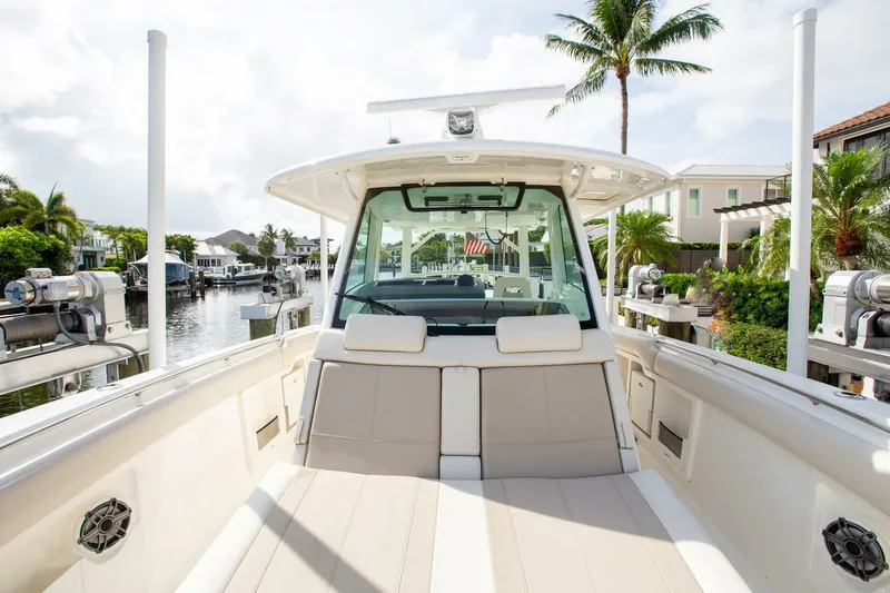 Double Nickel Yacht Photos Pics 2023 Boston Whaler 380 Outrage docked, showcasing spacious seating and modern design.