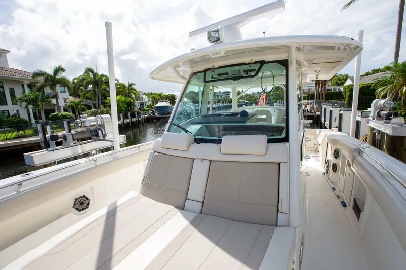 Double Nickel Yacht Photos Pics 2023 Boston Whaler 380 Outrage boat docked, showcasing spacious seating and sleek design.