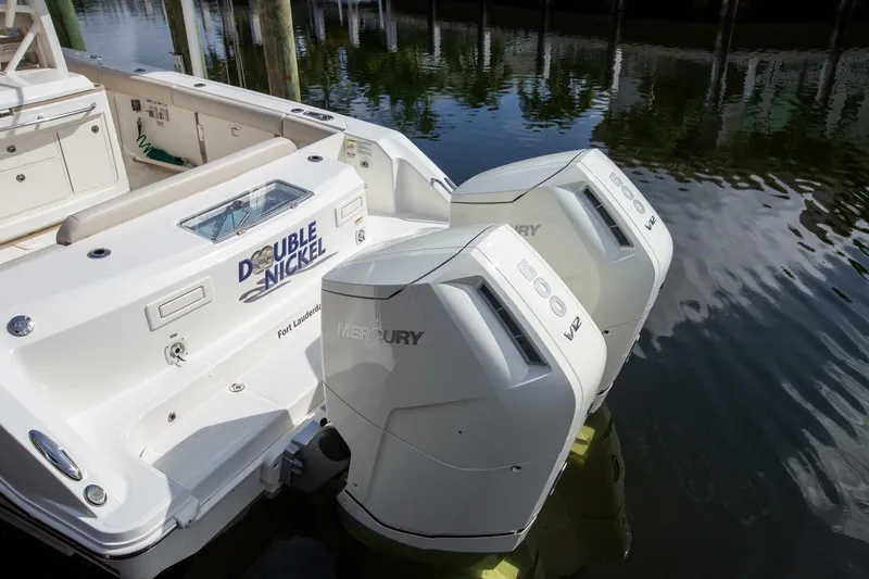 Double Nickel Yacht Photos Pics 2023 Boston Whaler 380 Outrage with dual Mercury V12 engines docked in water.
