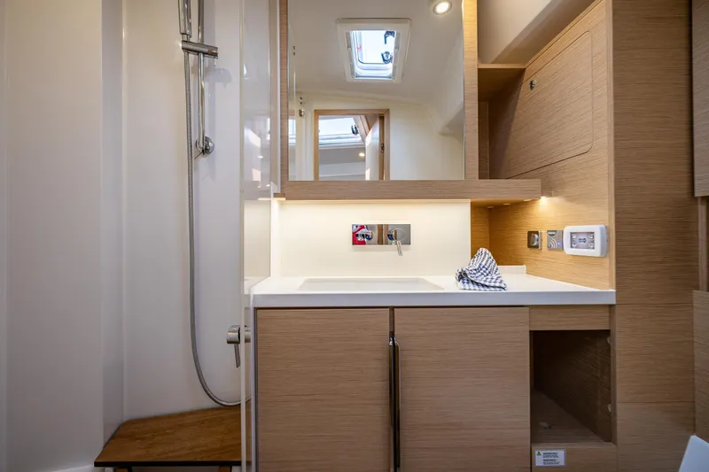San-197 Yacht Photos Pics Modern bathroom interior of 2025 Hanse 460 yacht with wooden cabinetry and sleek fixtures.