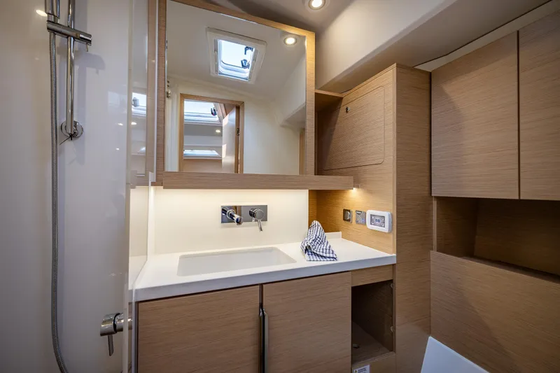 San-197 Yacht Photos Pics Modern bathroom interior of 2025 Hanse 460 yacht with wooden cabinetry and sleek fixtures.