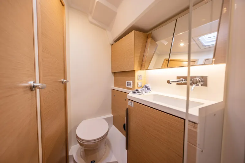 San-197 Yacht Photos Pics Modern bathroom interior of 2025 Hanse 460 yacht with sleek wood finishes.