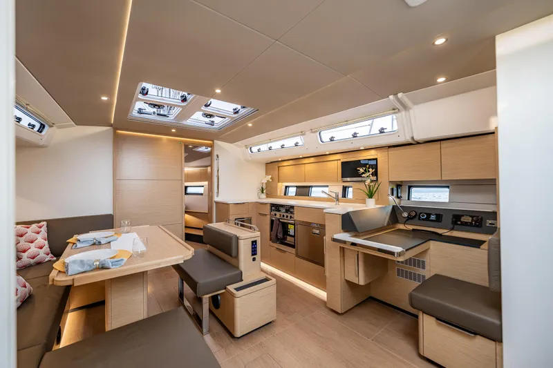 San-197 Yacht Photos Pics Luxurious interior of 2025 Hanse 460 yacht with modern kitchen and dining area.