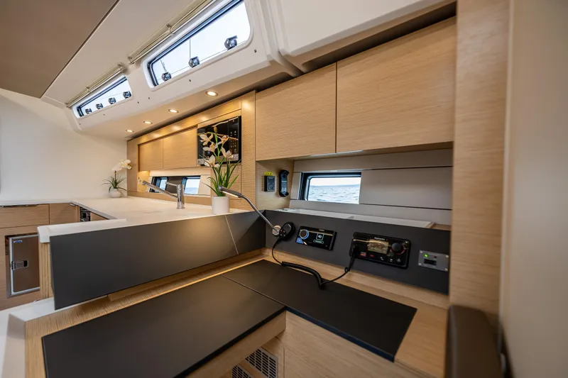 San-197 Yacht Photos Pics Modern interior of 2025 Hanse 460 yacht with sleek kitchen design and natural wood finishes.