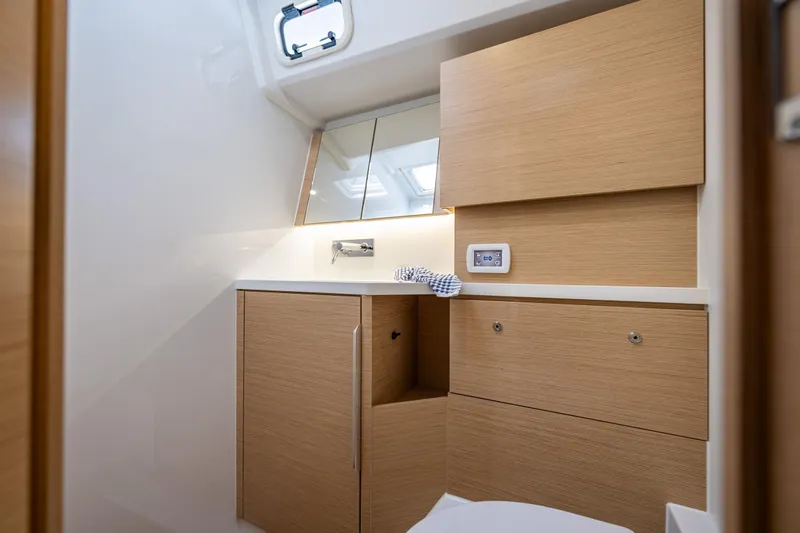 San-197 Yacht Photos Pics Modern bathroom interior on 2025 Hanse 460 yacht, featuring sleek wooden cabinetry.