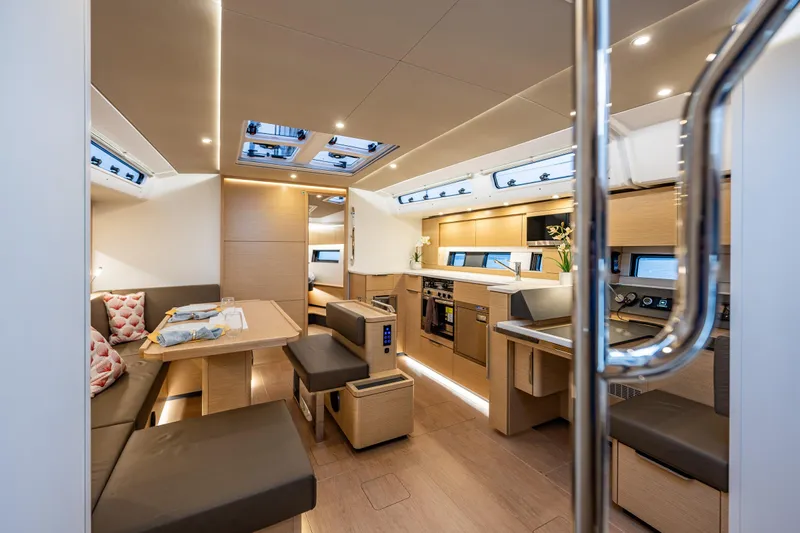 San-197 Yacht Photos Pics Luxurious interior of 2025 Hanse 460 yacht with modern kitchen and dining area.