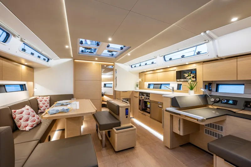 San-197 Yacht Photos Pics Luxurious interior of 2025 Hanse 460 yacht with modern kitchen and dining area.