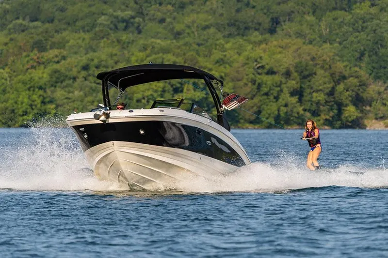  Yacht Photos Pics Manufacturer Provided Image: 2023 Sea Ray SDX 290 boat towing a wakeboarder on a lake.