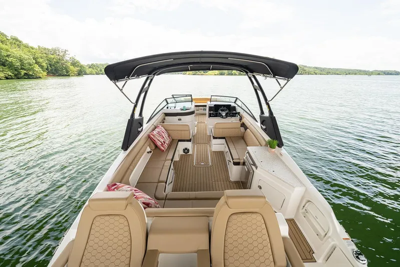  Yacht Photos Pics Manufacturer Provided Image: 2023 Sea Ray SDX 290 boat interior with tan seating and black canopy on a lake.