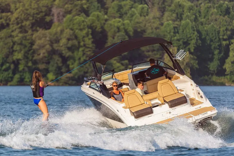  Yacht Photos Pics Manufacturer Provided Image: 2023 Sea Ray SDX 290 boat towing a wakeboarder on a lake.