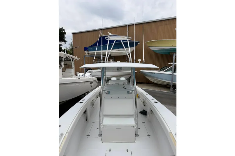  Yacht Photos Pics 2005 Jupiter 31 Center Console boat in a marina, surrounded by other vessels.