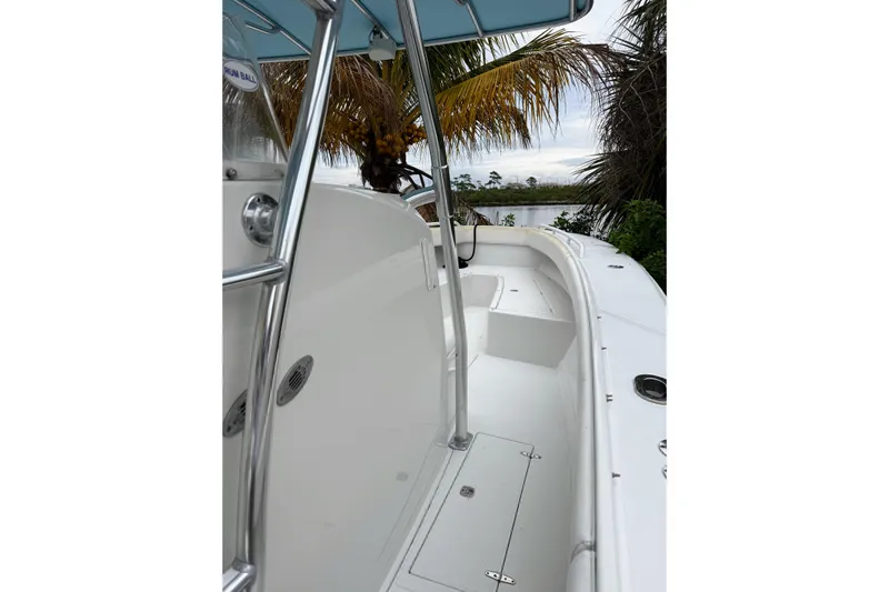  Yacht Photos Pics 2005 Jupiter 31 Center Console boat with sleek white deck and palm trees in background.
