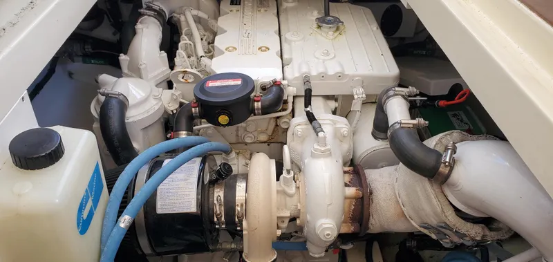 Puffin Yacht Photos Pics Engine compartment of a 2008 Legacy 32 boat, showcasing mechanical components and hoses.