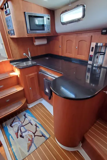 Puffin Yacht Photos Pics 2008 Legacy 32 yacht kitchen with wood cabinetry and modern appliances.