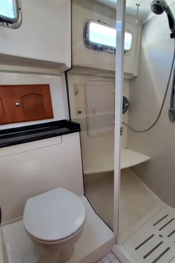 Puffin Yacht Photos Pics 2008 Legacy 32 yacht bathroom with shower, toilet, and storage cabinets.