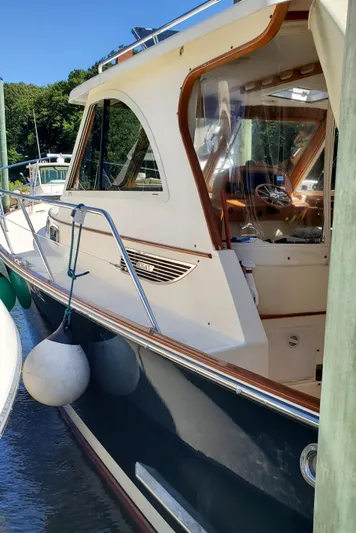 Puffin Yacht Photos Pics 2008 Legacy 32 boat docked, featuring classic design and wooden accents.