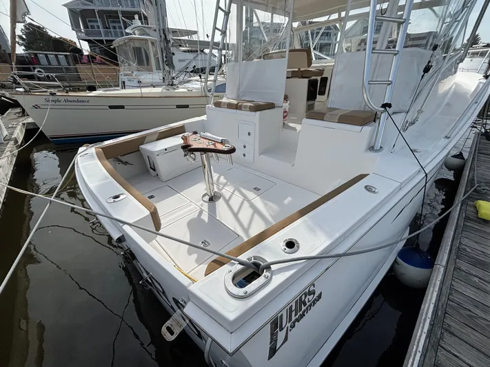 Sawbones Yacht Photos Pics 2011 Luhrs 37 Canyon IPS boat docked, featuring spacious deck and seating area.