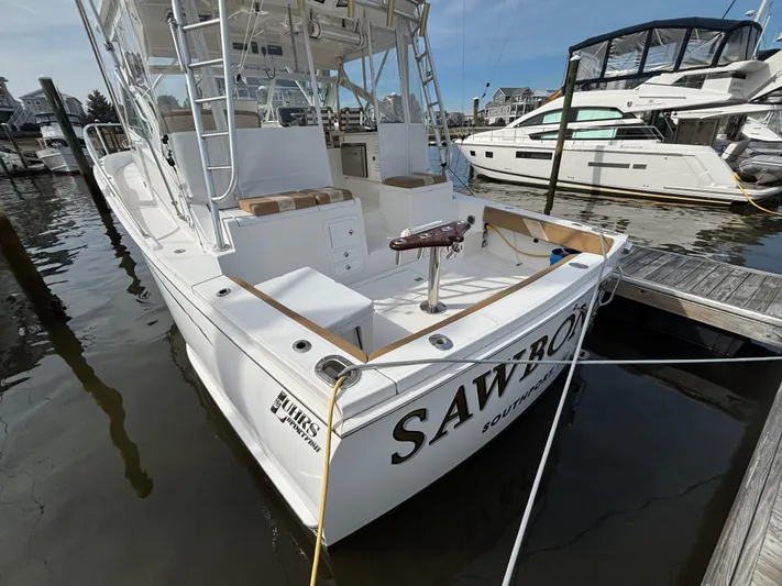 Sawbones Yacht Photos Pics 2011 Luhrs 37 Canyon IPS boat docked at marina, featuring spacious deck and seating.