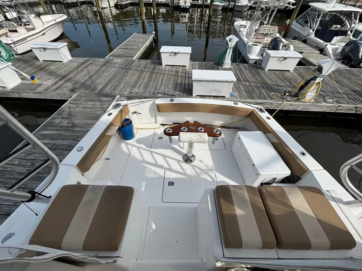 Sawbones Yacht Photos Pics 2011 Luhrs 37 Canyon IPS boat docked, featuring spacious seating and fishing rod holders.
