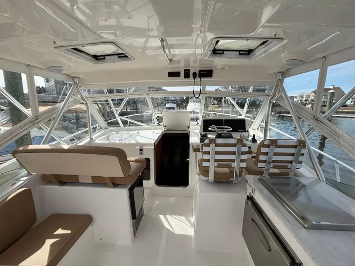 Sawbones Yacht Photos Pics Interior view of 2011 Luhrs 37 Canyon IPS boat, featuring helm and seating area.