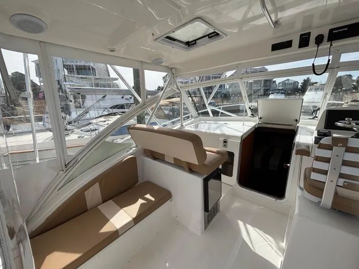 Sawbones Yacht Photos Pics Interior of 2011 Luhrs 37 Canyon IPS boat with seating and helm station.