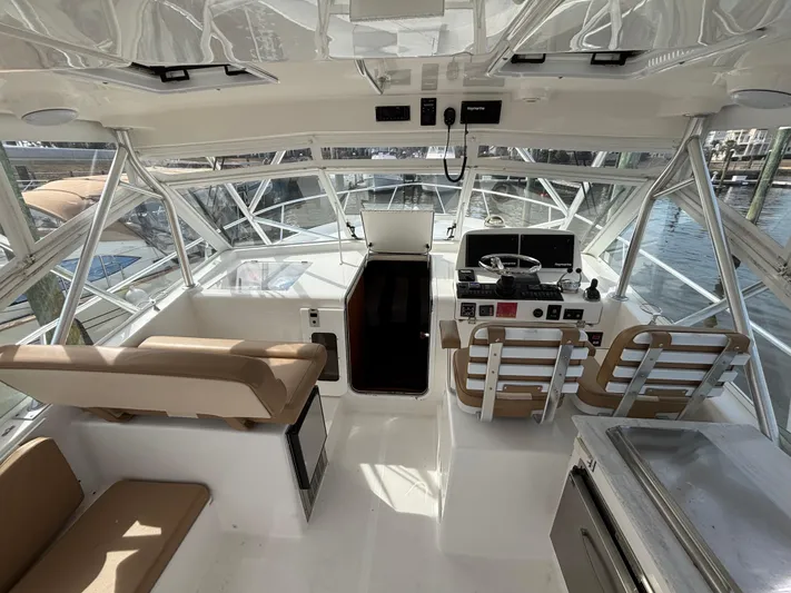 Sawbones Yacht Photos Pics 2011 Luhrs 37 Canyon IPS boat interior with helm, seating, and navigation equipment.