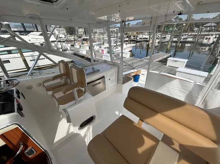 Sawbones Yacht Photos Pics Interior of 2011 Luhrs 37 Canyon IPS boat with beige seating and marina view.