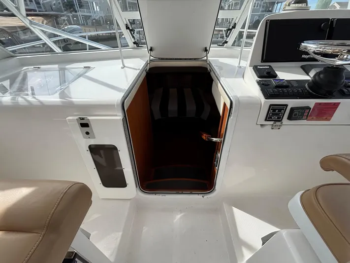 Sawbones Yacht Photos Pics 2011 Luhrs 37 Canyon IPS boat interior with open hatch and control panel.