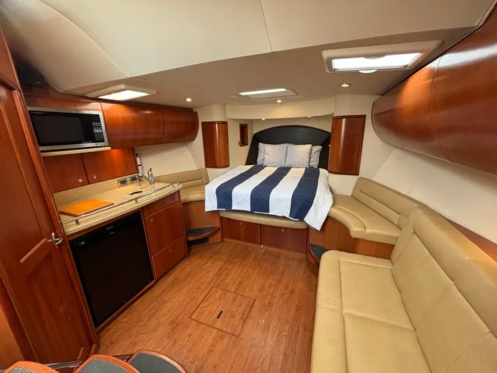 Sawbones Yacht Photos Pics Interior of 2011 Luhrs 37 Canyon IPS yacht with bed, kitchenette, and seating area.