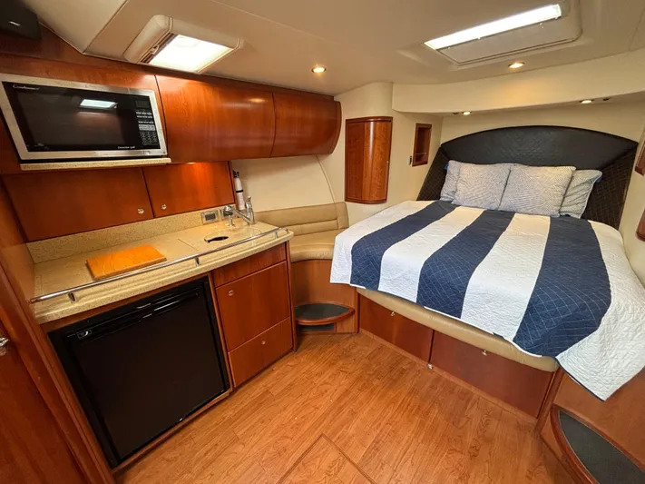 Sawbones Yacht Photos Pics 2011 Luhrs 37 Canyon IPS cabin with bed, kitchenette, and wood finish.