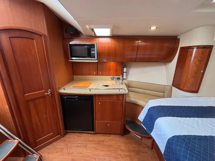 Sawbones Yacht Photos Pics Interior of 2011 Luhrs 37 Canyon IPS yacht with kitchenette and seating area.