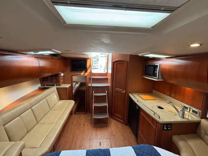 Sawbones Yacht Photos Pics Interior of 2011 Luhrs 37 Canyon IPS yacht with modern kitchen and seating area.