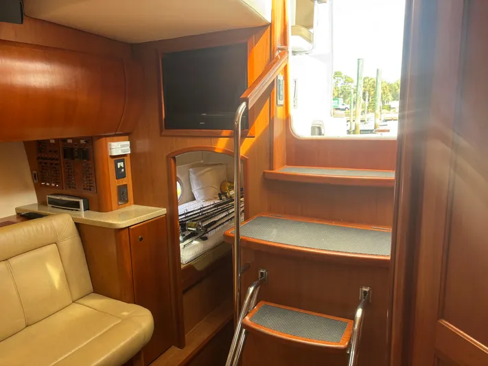 Sawbones Yacht Photos Pics Interior of 2011 Luhrs 37 Canyon IPS yacht with wooden stairs and seating area.