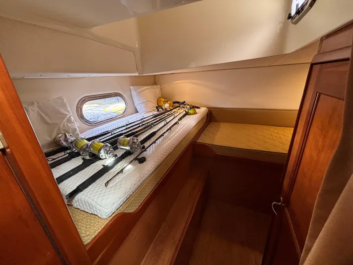Sawbones Yacht Photos Pics 2011 Luhrs 37 Canyon IPS cabin with fishing rods on bed.