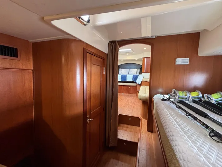 Sawbones Yacht Photos Pics Interior of 2011 Luhrs 37 Canyon IPS boat with wooden finishes and fishing rods.