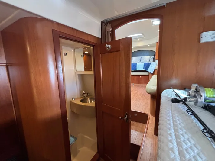 Sawbones Yacht Photos Pics 2011 Luhrs 37 Canyon IPS interior with wood finish, bathroom, and cozy sleeping area.