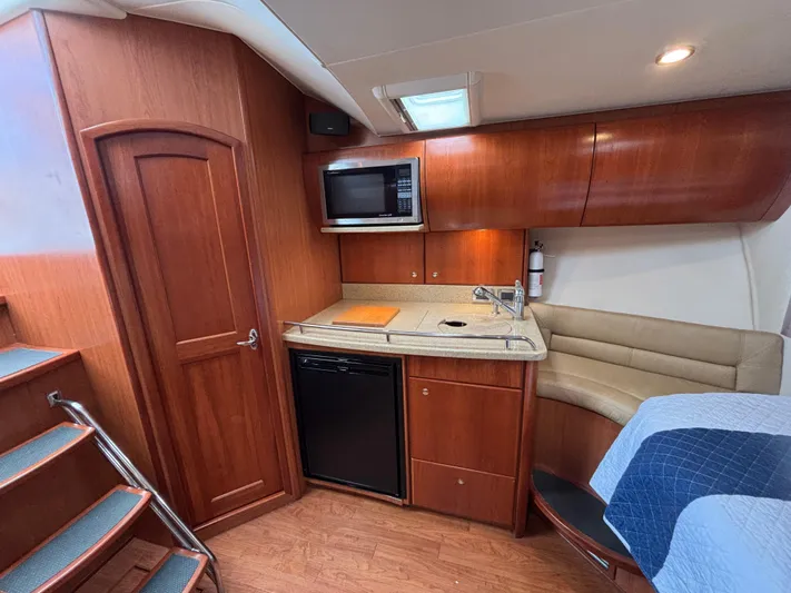 Sawbones Yacht Photos Pics Interior of 2011 Luhrs 37 Canyon IPS yacht with kitchenette and seating area.