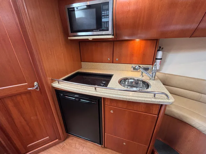 Sawbones Yacht Photos Pics 2011 Luhrs 37 Canyon IPS yacht kitchen with microwave, stove, sink, and fridge.