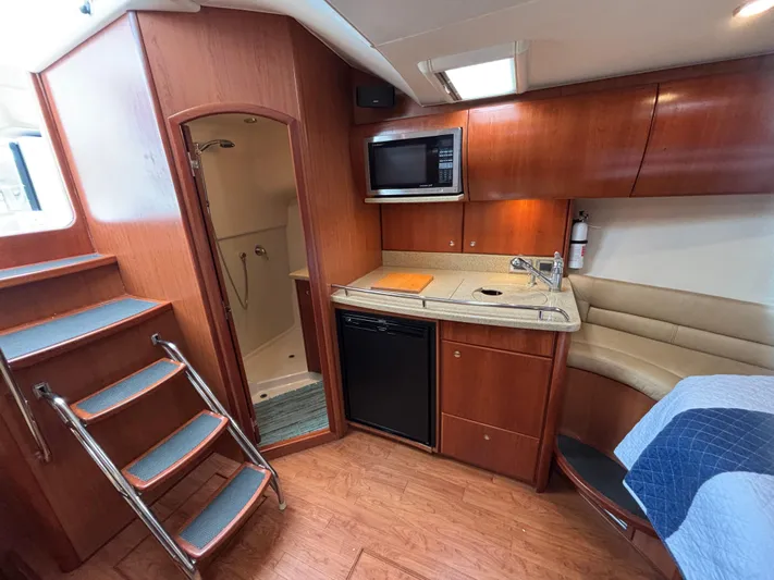 Sawbones Yacht Photos Pics Interior of 2011 Luhrs 37 Canyon IPS yacht with kitchenette and seating area.