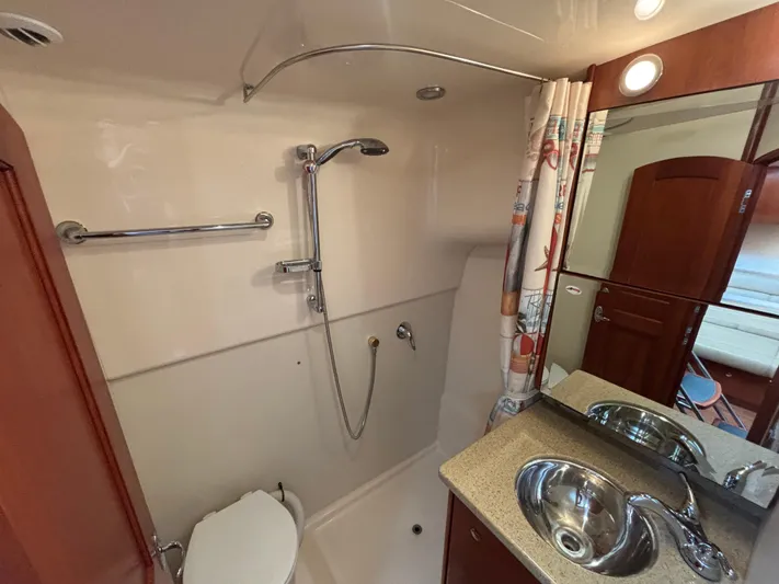Sawbones Yacht Photos Pics Bathroom interior of 2011 Luhrs 37 Canyon IPS yacht, featuring shower, sink, and mirror.