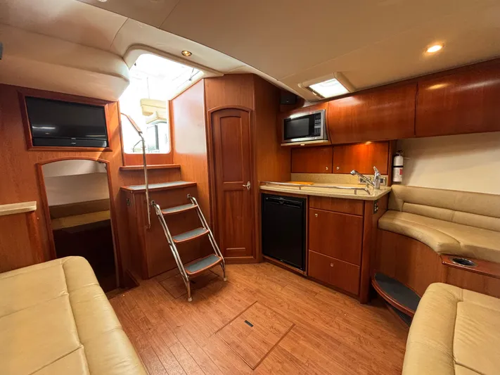 Sawbones Yacht Photos Pics Interior of 2011 Luhrs 37 Canyon IPS yacht with kitchen and seating area.