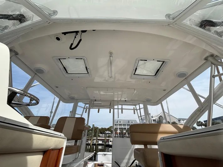 Sawbones Yacht Photos Pics Interior view of 2011 Luhrs 37 Canyon IPS boat, featuring seating and helm area.