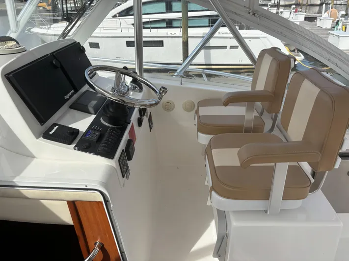 Sawbones Yacht Photos Pics 2011 Luhrs 37 Canyon IPS helm with dual beige seats and navigation controls.