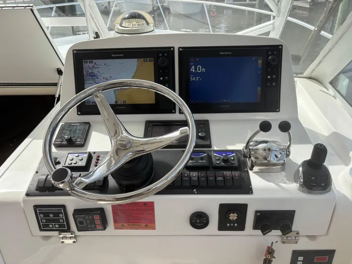 Sawbones Yacht Photos Pics Helm of 2011 Luhrs 37 Canyon IPS with navigation screens and controls.