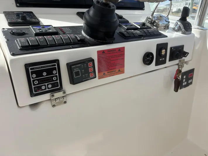 Sawbones Yacht Photos Pics Control panel of a 2011 Luhrs 37 Canyon IPS boat with various switches and controls.