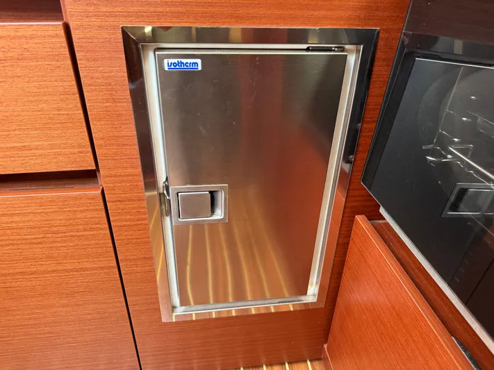 Dreamcatcher Yacht Photos Pics Stainless steel door on 2018 Hanse 348 yacht interior, featuring wooden cabinetry.