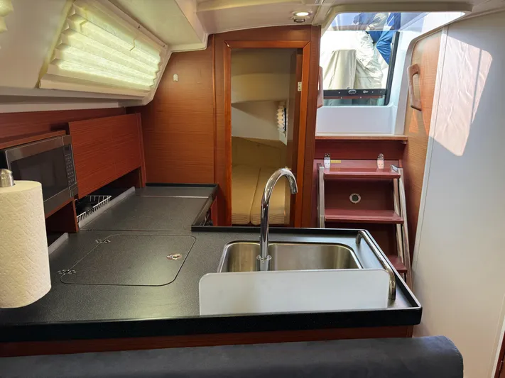 Dreamcatcher Yacht Photos Pics Interior of 2018 Hanse 348 yacht, featuring modern kitchen with sink and wooden cabinetry.