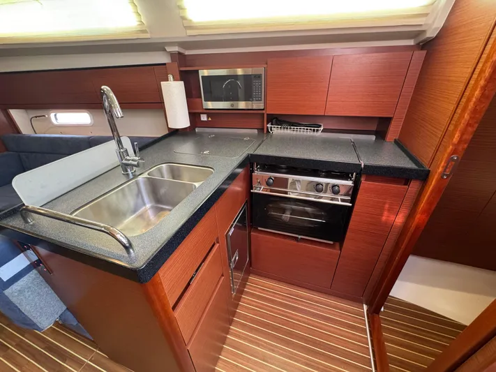 Dreamcatcher Yacht Photos Pics 2018 Hanse 348 yacht kitchen with modern appliances and wood cabinetry.