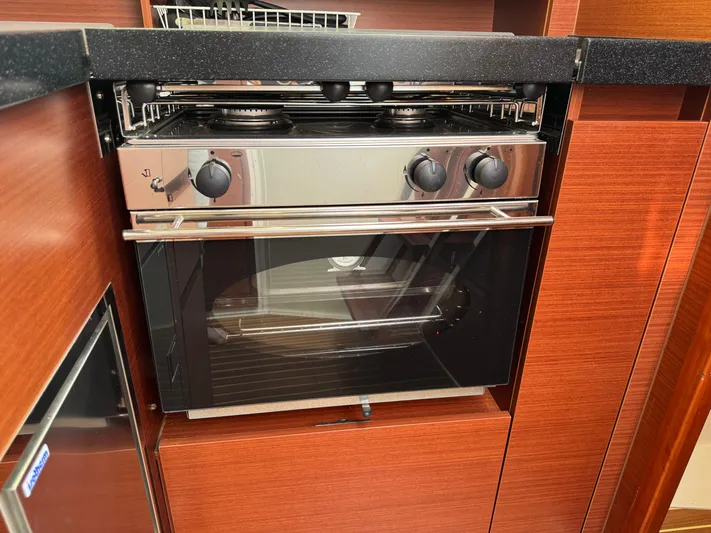 Dreamcatcher Yacht Photos Pics Modern kitchen oven in 2018 Hanse 348 yacht, featuring sleek wood cabinetry.