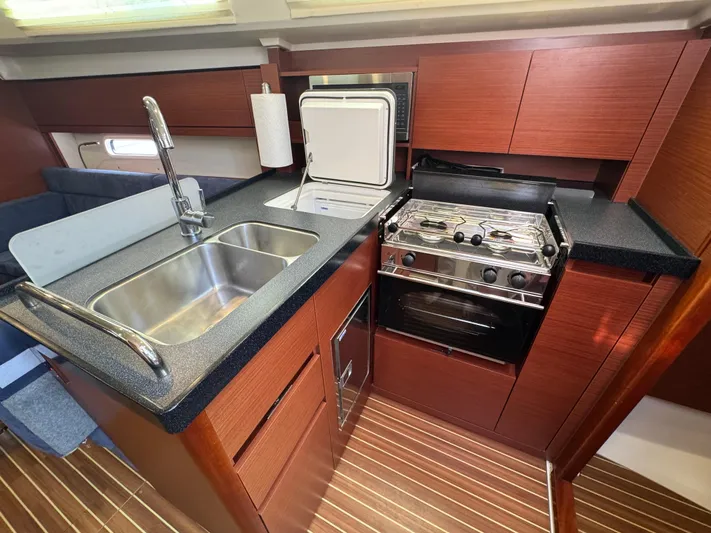 Dreamcatcher Yacht Photos Pics 2018 Hanse 348 yacht kitchen with sink, stove, and wooden cabinetry.